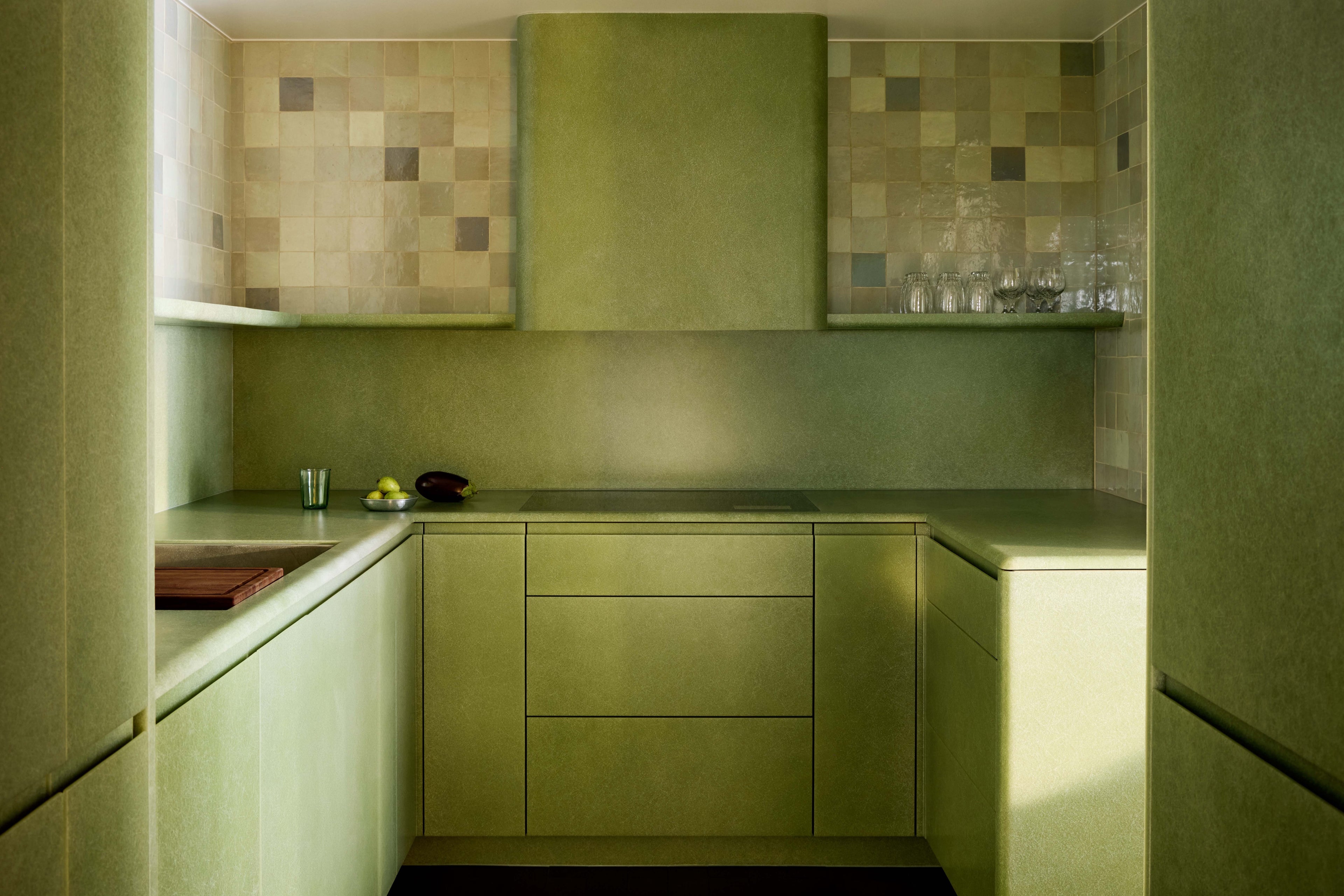 Custom fiberglass kitchen by VAVA Objects for Studio AHEAD's The World Residence, with Moroccan zellige backsplash in sea-shades of green
